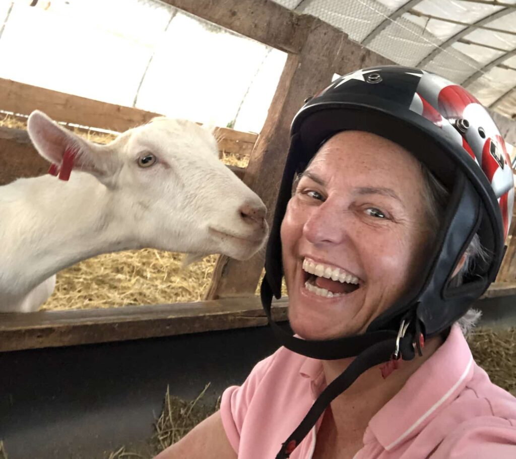 person smiling with goat