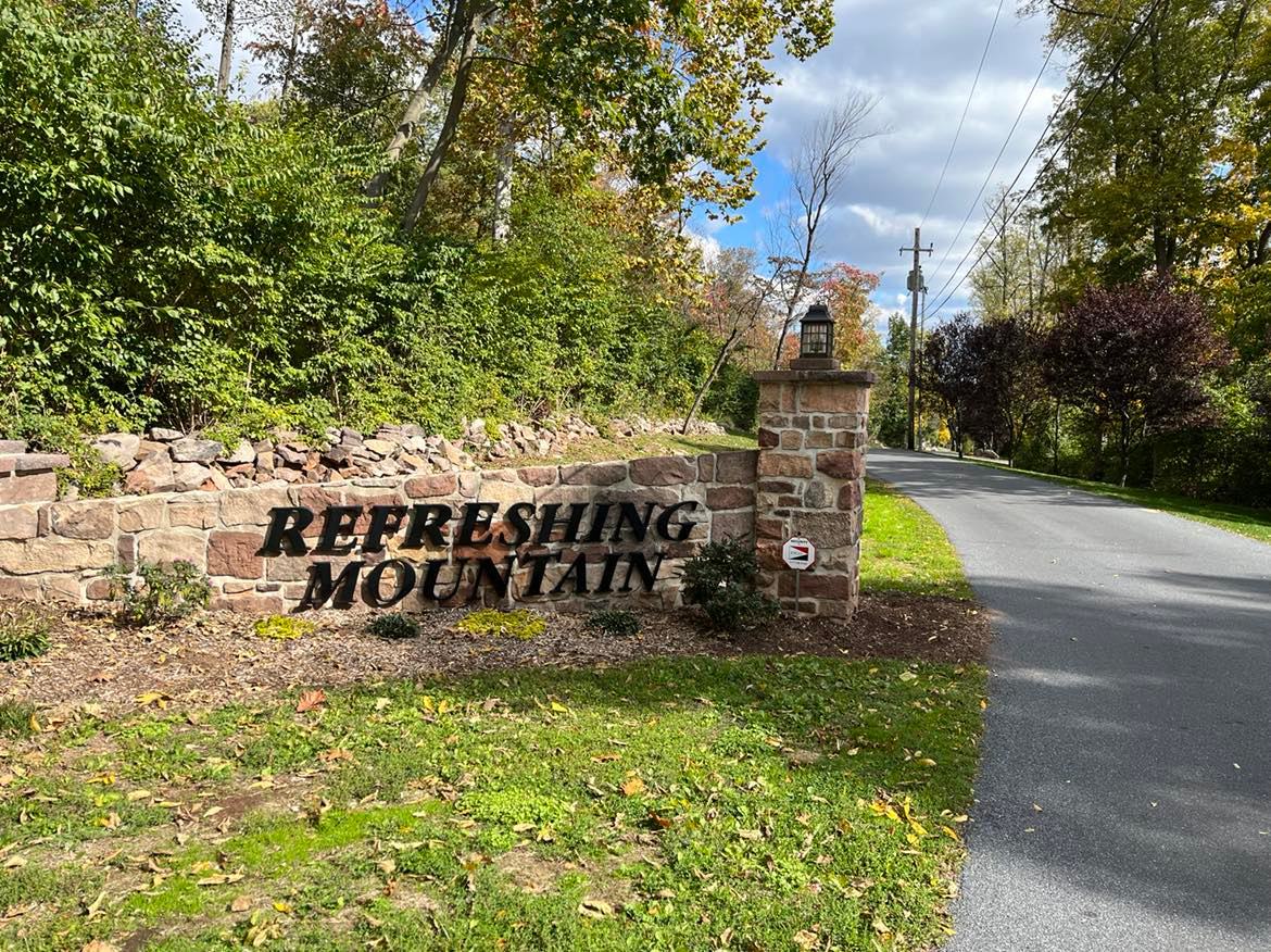 Stone Wall with Refreshing Mountain Sign