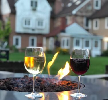 Wine and Fire Pit with historic bed and breakfast in background
