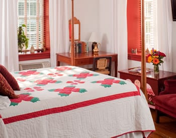 View of the Red Rose room with bed and desk